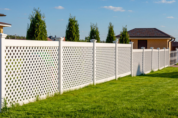 White vinyl fence on a residential property.